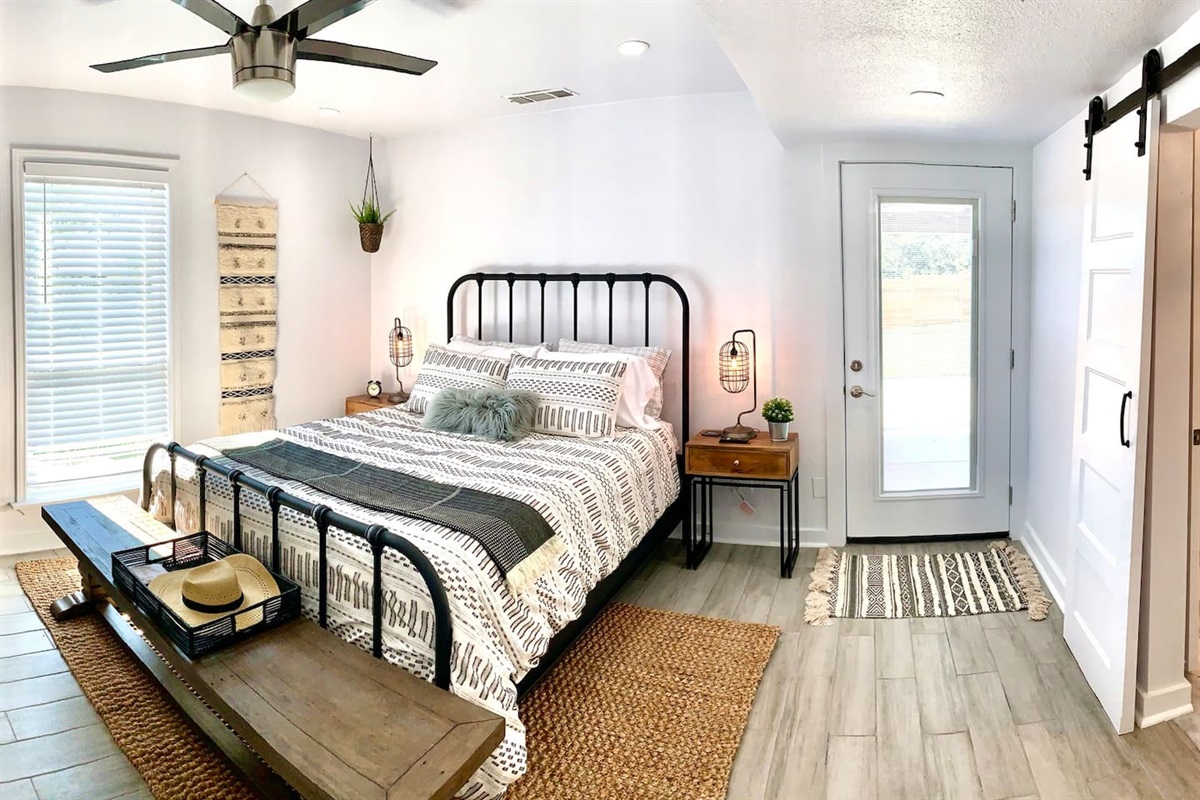 Our main-level master en suite complete with Purple mattress, flat screen TV, marble bath, and private door to pool area.